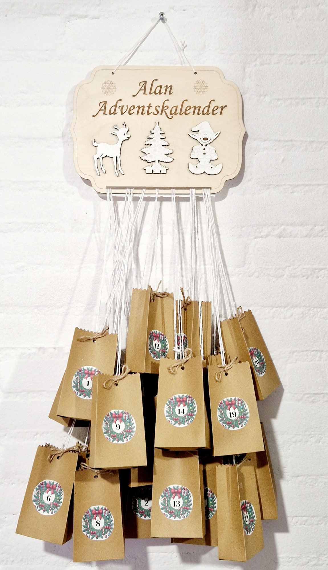 Adventskalender met houten naambord en 24 genummerde kraftzakjes