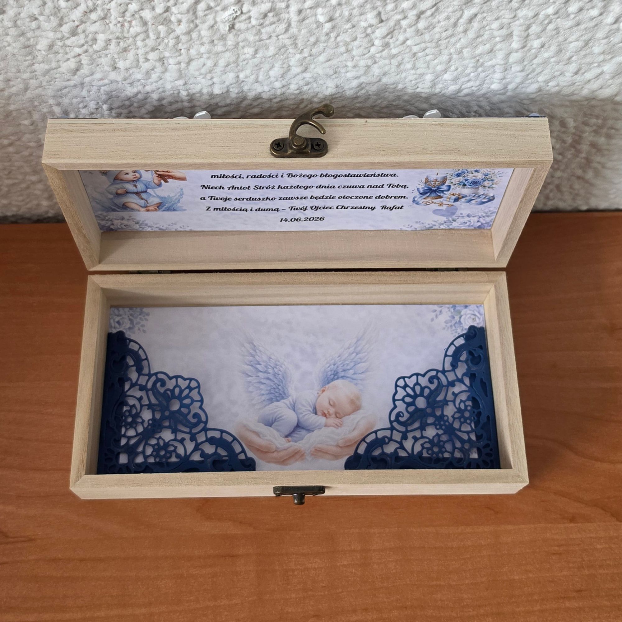 De doopbox open, met engelenprint en wens